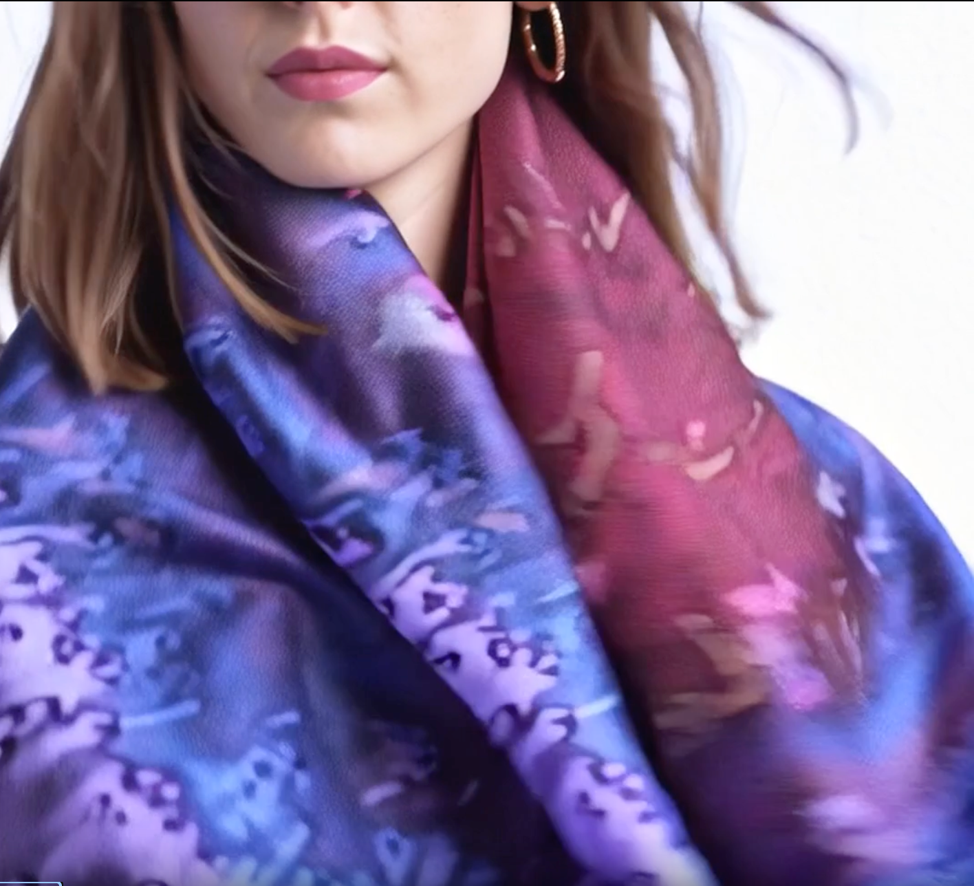 A girl with a beautiful silk scarf designed by Maryam mohi as wearable art and silk accessory
