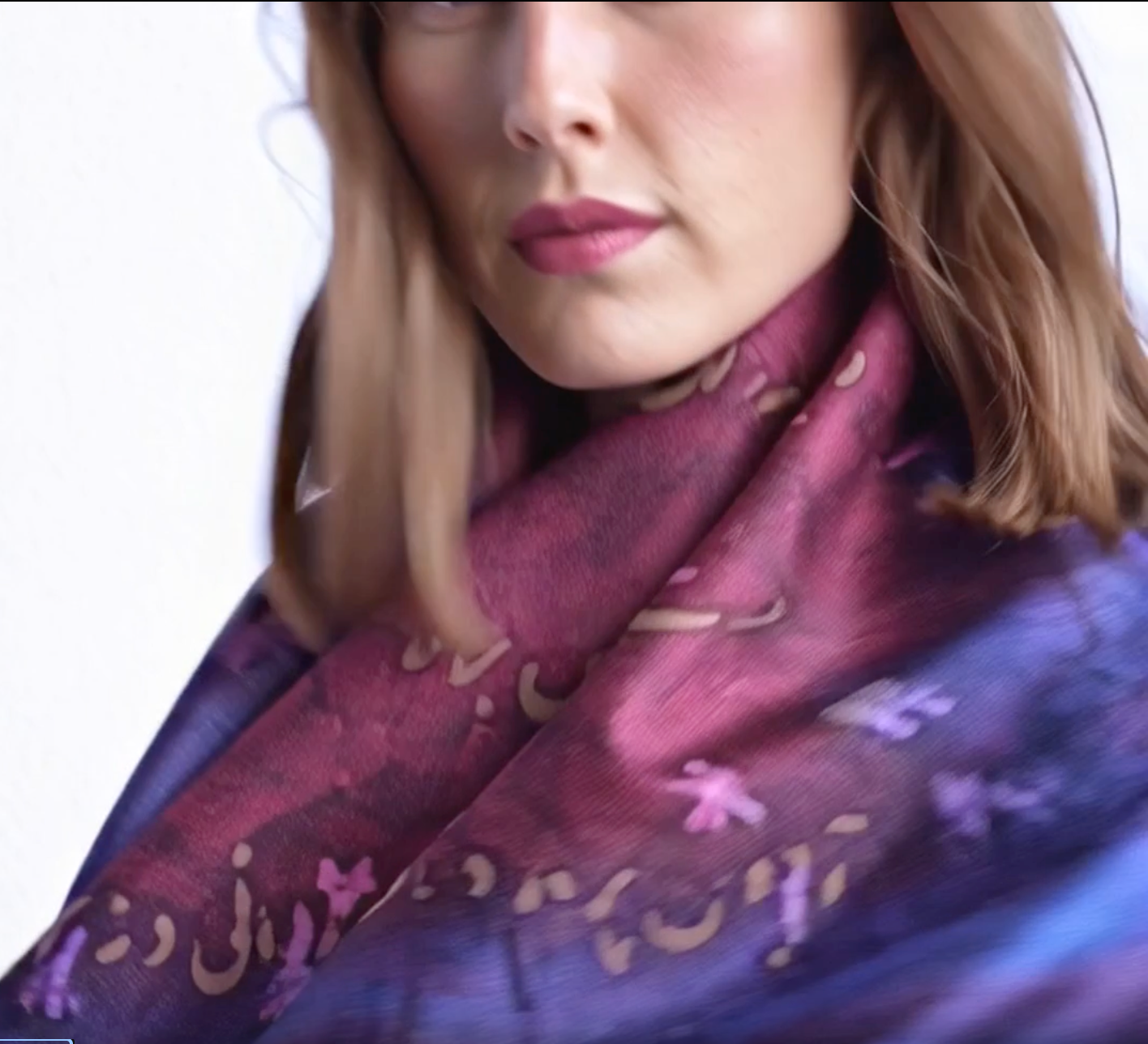 Woman wearing a purple patterned scarf with person calligraphy on a white background designed by Maryam Mohi