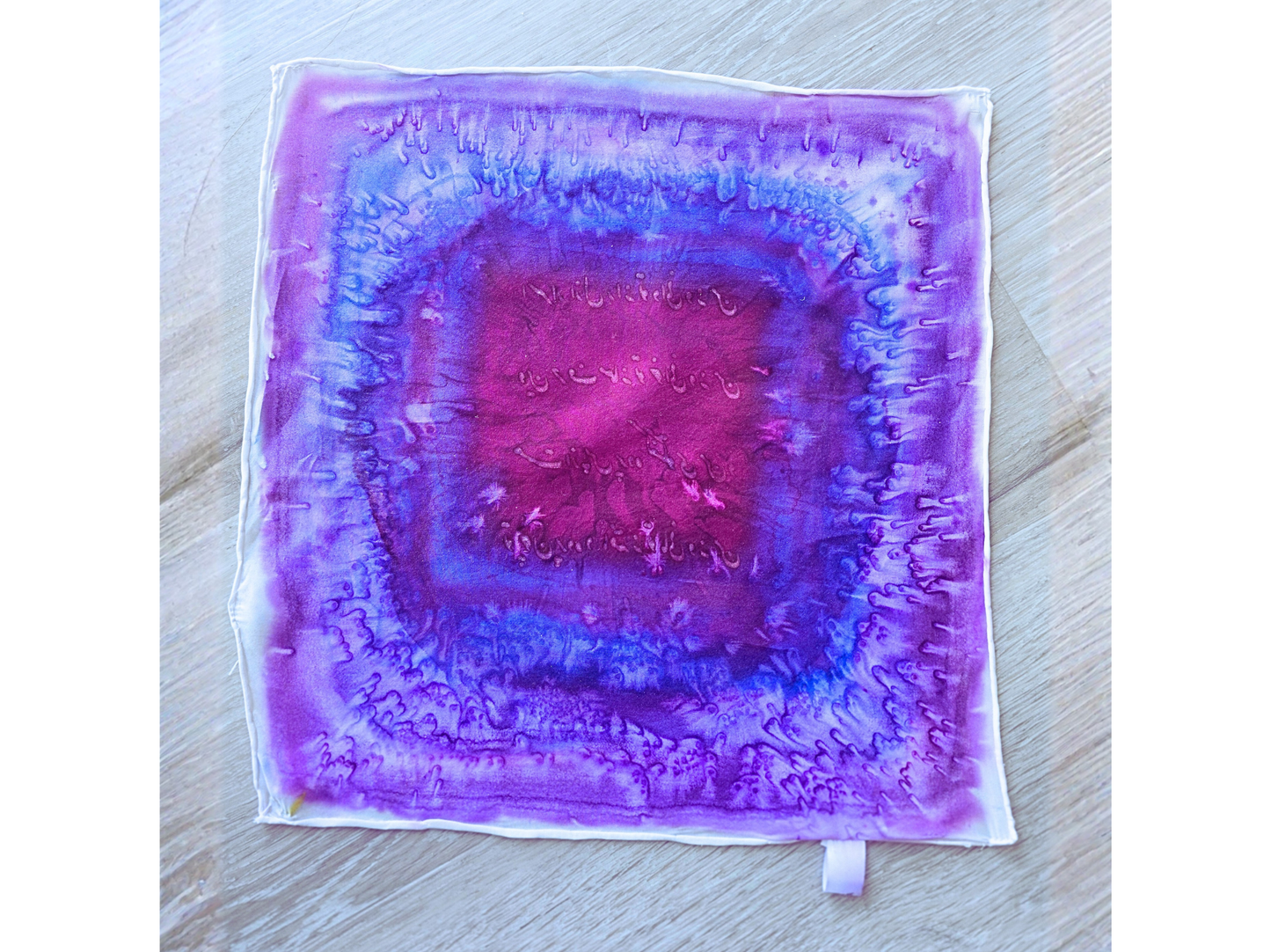 Woman wearing a purple patterned scarf on a white background designed by Maryam Mohi