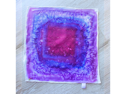 Woman wearing a purple patterned scarf on a white background designed by Maryam Mohi